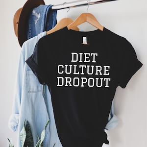 May include: Black t-shirt with white text that reads "DIET CULTURE DROPOUT".