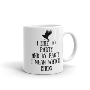May include: White ceramic mug with a black silhouette of a bird and the text "I like to party and by party I mean watch birds".
