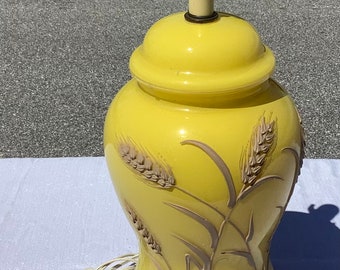 A Mid-Century Yellow Ceramic Lamp With Floral Design