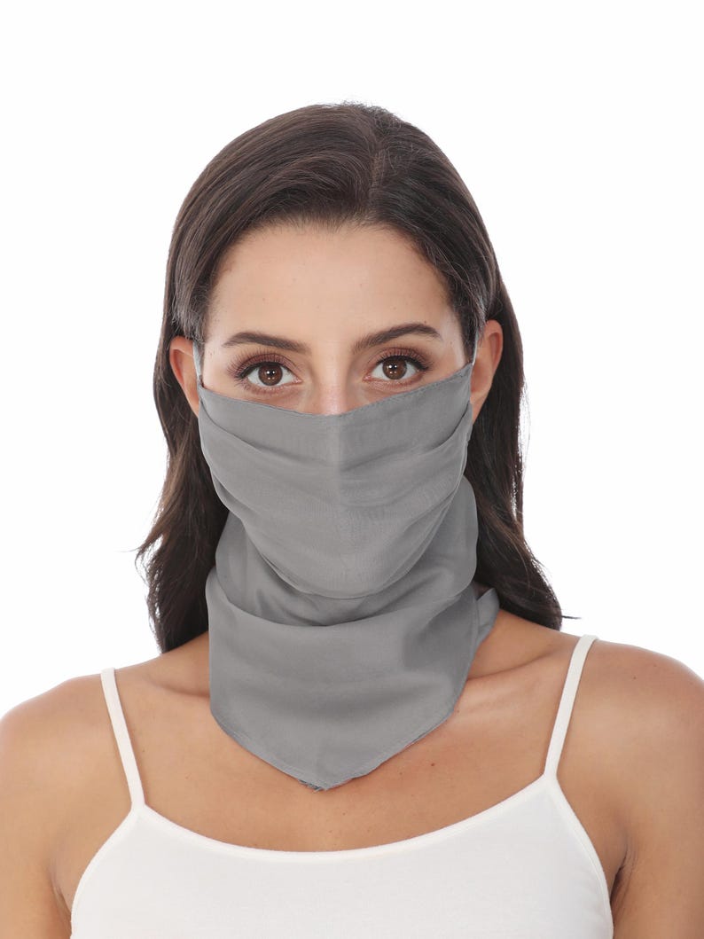 May include: A solid grey face covering that extends down to the neck, featuring a pleated design across the nose and mouth area. The fabric is smooth and opaque, providing full coverage from the bridge of the nose to the base of the throat.