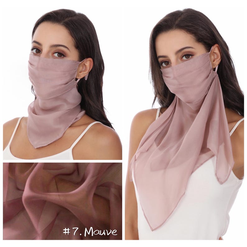 May include: A mauve-coloured face mask made of a sheer, lightweight fabric. The mask features a pleated design over the nose and mouth area, with an attached triangular scarf-like drape that extends downwards to cover the neck and upper chest area.