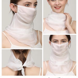 May include: A white, semi-sheer fabric face covering that extends into a scarf, featuring ear loops for secure placement and a tie closure at the back of the neck. The accessory is labelled #1_White and provides coverage for the nose, mouth, and neck.