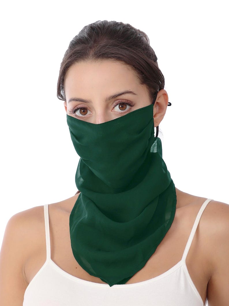 May include: A dark green face covering made of a lightweight, semi-sheer fabric. The accessory features a draped, scarf-like design that covers the nose and mouth, extending down to the neck and chest area with soft, flowing folds of material.