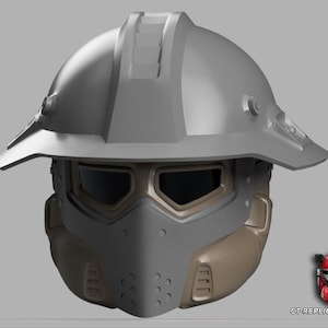 May include: A gray and tan helmet with a visor and a brim. The helmet has a futuristic design, with a detailed face covering and a top section with ridges. The image includes a small logo of a helmet in the bottom right corner.