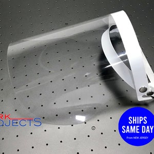 May include: White plastic face shield with a clear visor and adjustable headband. The shield is designed to protect the wearer's face from droplets.
