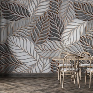May include: A dining room with a gray leaf-patterned wall, a wooden table, and four wooden chairs. The wall features a repeating pattern of stylized leaves in shades of gray, white, and brown. The floor is made of dark wood planks.
