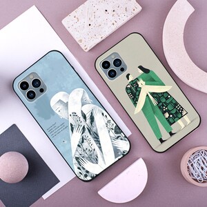 May include: Two phone cases with different designs. One case features a white silhouette of two people embracing with a blue and white background. The other case features two people in green and black clothing with a floral pattern on a beige background. Both cases have a black border and a camera cutout.