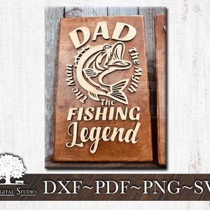 May include: A wooden sign with the text "DAD The Man The Myth The FISHING Legend" and a carved image of a fish.