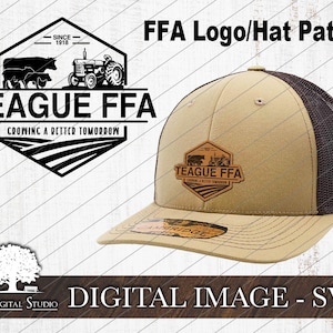May include: A brown and black baseball cap with a brown mesh back. The front of the cap has a brown leather patch with the text "TEAGUE FFA" and a small image of a tractor and cows. The text "CROWNING A BETTER TOMORROW" is also on the patch.