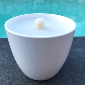 May include: White ceramic bowl with a white candle inside. The candle has a single wick.