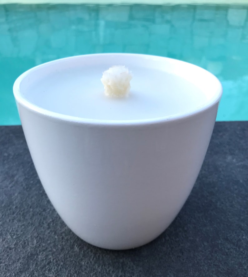 May include: White ceramic bowl with a white candle inside. The candle has a single wick.