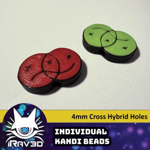 May include: Two 4mm cross hybrid hole kandi beads. One bead is red with a black outline and the other is green with a black outline. Both beads have a smiley face design.