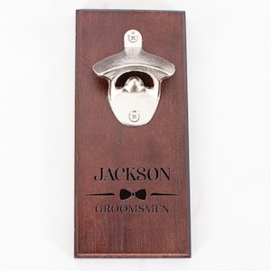 May include: A wooden bottle opener with a metal opener and the text "JACKSON GROOMSMEN" with a bowtie graphic.
