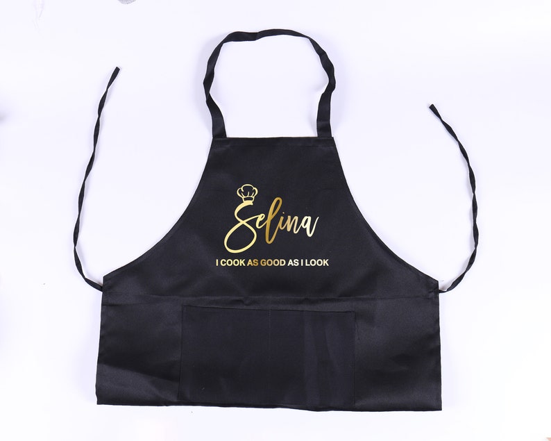 May include: Black apron with a gold  "Selina I cook as good as I look" text.