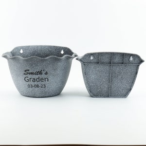 May include: Two gray plastic wall planters with drainage holes. The larger planter has a scalloped edge and the text "Smith's Garden 03-08-23" printed on the front.