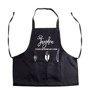 May include: Black apron with a white chef hat and the name "Jayden" and the text "I cook as good as I look".