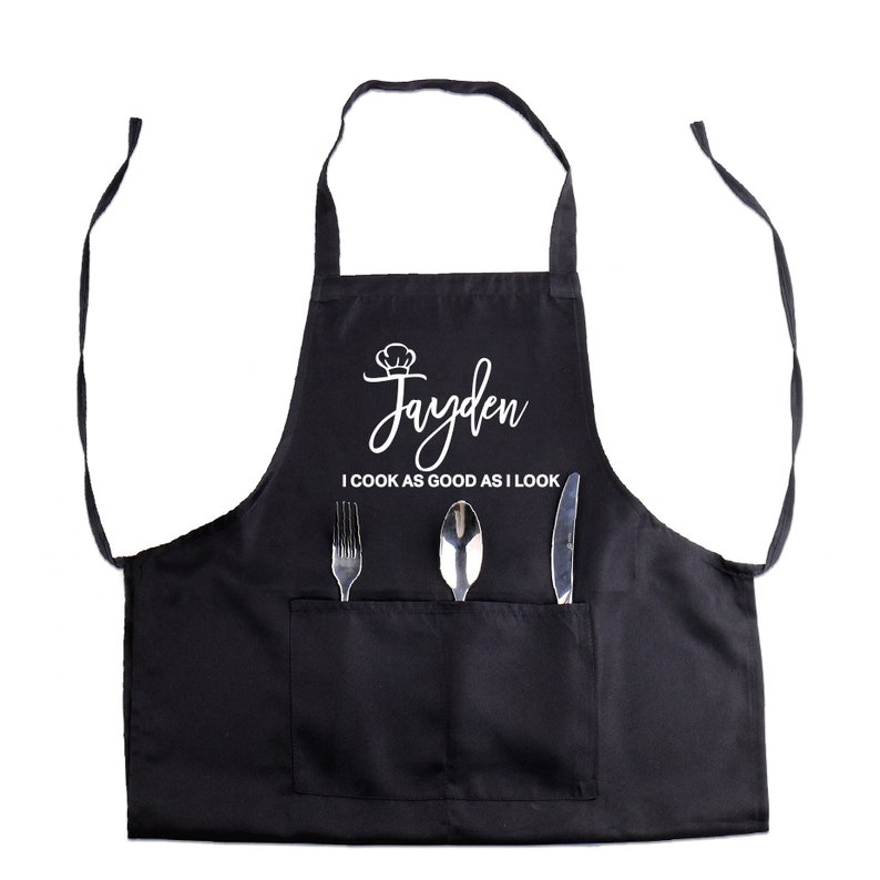 May include: Black apron with a white chef hat and the name "Jayden" and the text "I cook as good as I look".