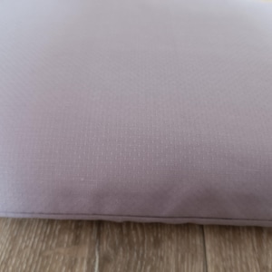 May include: A light purple cushion with a textured surface.