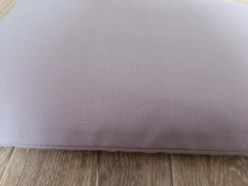 May include: A light purple cushion with a textured surface.