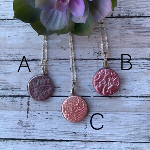 Polymer clay necklace with a unique design.