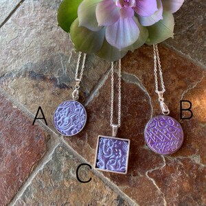 Polymer clay necklace with a unique design.