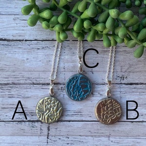 Polymer clay necklace with a unique design.
