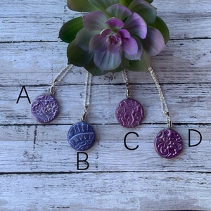 Polymer clay necklace with a unique design.