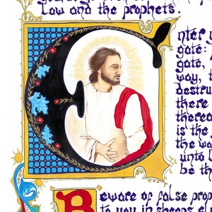 May include: An illuminated manuscript page featuring elaborate calligraphy and a portrait of a man in white robes and a red shawl. The large letter "C" is decorated with blue and red floral accents. Text includes "Law and the prophets."