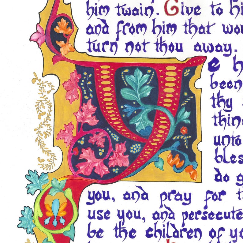 May include: Close-up of an illuminated manuscript page with ornate calligraphy. A large, stylized red letter "J" is central, adorned with blue, green, and pink floral motifs. The background is a deep blue, with gold and white text surrounding the letter.