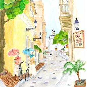 May include: Watercolor painting of a European street scene with two figures holding umbrellas and bicycles. Buildings in shades of yellow and tan line the cobblestone street. A sign for "The Crawfish Cafe" is visible.