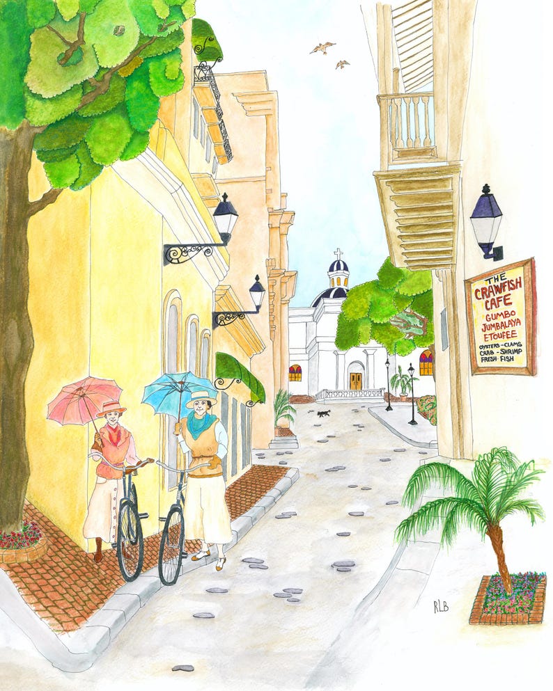 May include: Watercolor painting of a European street scene with two figures holding umbrellas and bicycles. Buildings in shades of yellow and tan line the cobblestone street. A sign for "The Crawfish Cafe" is visible.