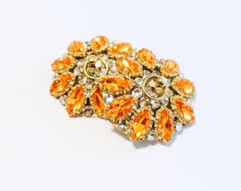 Par de cubrepezones con forma de diamante y pedrería naranja