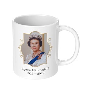 May include: White ceramic mug with a gold-framed image of Queen Elizabeth II. The image is surrounded by a decorative gold border. The text "Queen Elizabeth II 1926 - 2022" is printed below the image.