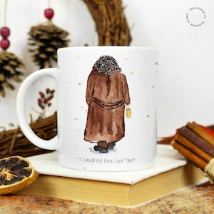 May include: White ceramic mug featuring a watercolour illustration of a person in a brown coat walking away with a lantern. The text "I Should Not Have Said That!" is printed on the bottom of the mug.
