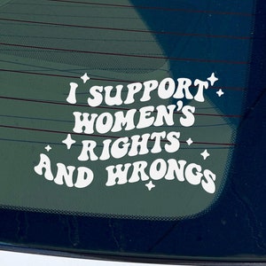 May include: White vinyl sticker on a car window that reads "I support women's rights and wrongs".