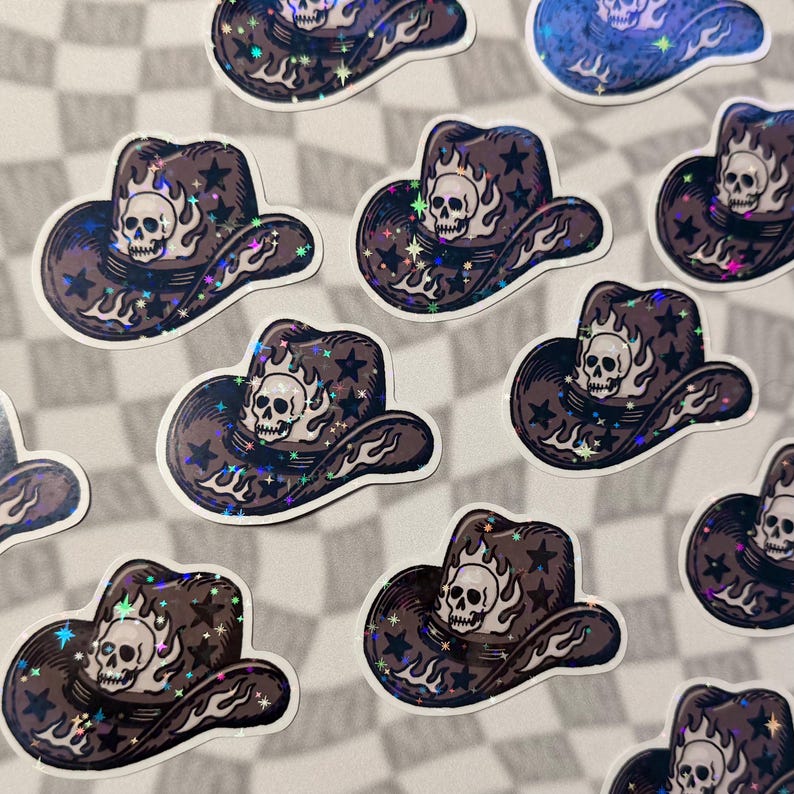 Scattered skull cowboy hat stickers with emo western aesthetic on a grey checkered surface.