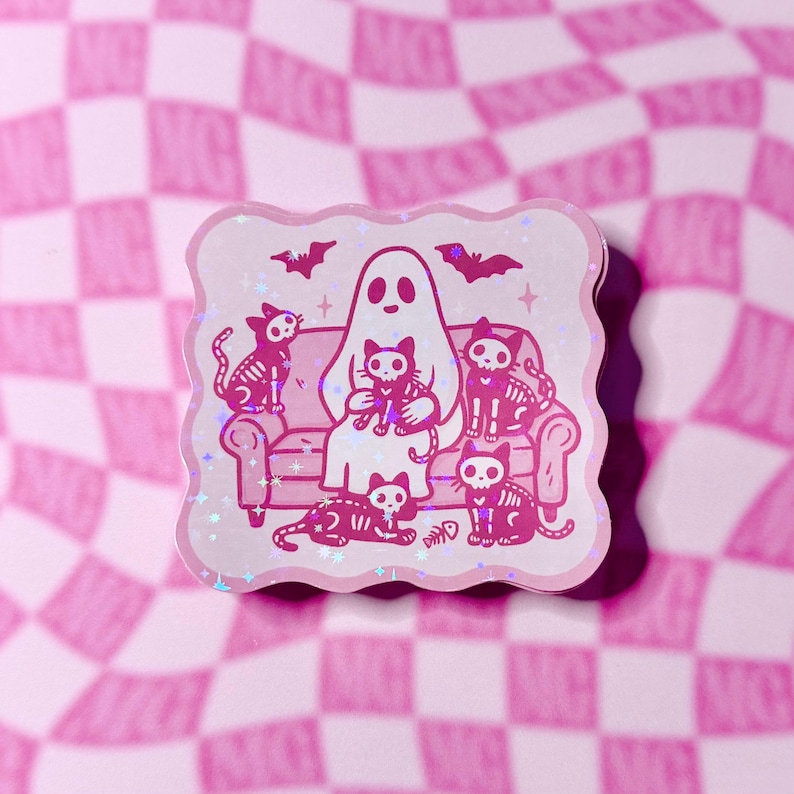 Holographic ghost sticker sitting on a couch with a bunch of skeleton cats, placed on a groovy checkered background with sparkly stars.