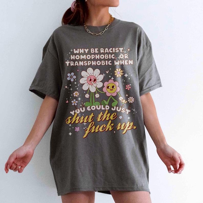 Model wearing Charcoal tee of why be racist, homophobic, or transphobic when you could just shut the f up tee.