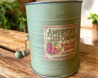 Repurposed flour sifter w/ seed label.