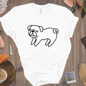 May include: White t-shirt with a black line drawing of a pug dog.