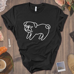 May include: Black t-shirt with a white outline drawing of a pug dog.