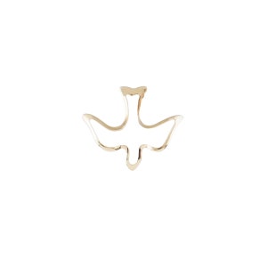 May include: A gold-coloured metal dove cutout, a symbol of peace and hope.