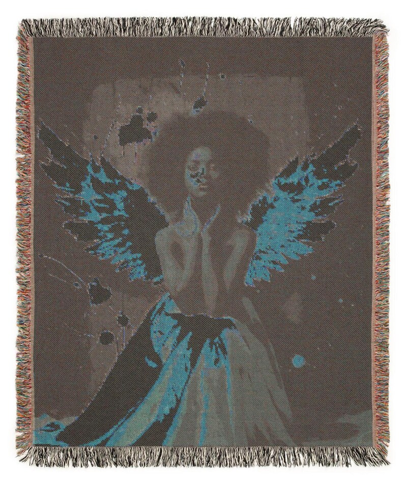 May include: A woven throw blanket featuring an artistic depiction of a figure with teal-colored wings. The figure is set against a dark background with teal accents. The blanket has a fringed edge in shades of brown and tan.