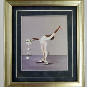 May include: Framed artwork featuring a dancer in a white leotard and ballet shoes, gracefully bending backward. The dancer holds white flowers, with some falling. The artwork is framed in gold and black.