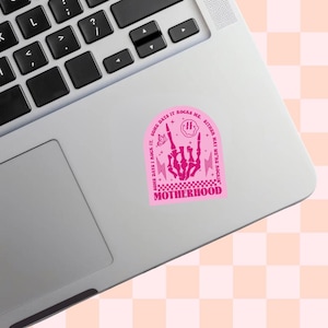 Pu&ograve; includere: Un adesivo rosa su un laptop con una mano di scheletro che fa un gesto rock and roll. L'adesivo ha il testo "SOME DAYS I ROCK IT. SOME DAYS IT ROCKS ME. EITHER WAY WE'RE ROCKIN' MOTHERHOOD".