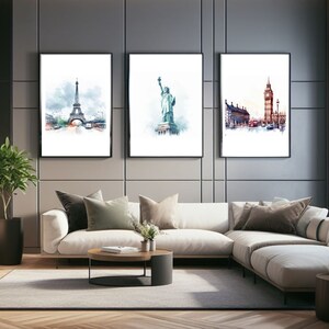May include: Three framed watercolor paintings of famous landmarks. The first painting shows the Eiffel Tower in Paris, France. The second painting shows the Statue of Liberty in New York City, USA. The third painting shows Big Ben and the Houses of Parliament in London, England.