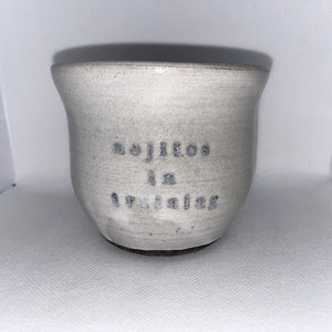 May include: A white ceramic mug with the text "Mojitos in the making" written on it.