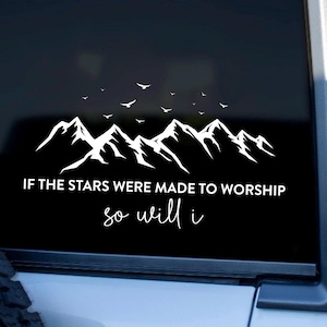 May include: White vinyl decal showing a mountain range silhouette with birds in flight. The text reads "IF THE STARS WERE MADE TO WORSHIP so will i" in a modern font. The decal is applied to a black surface.
