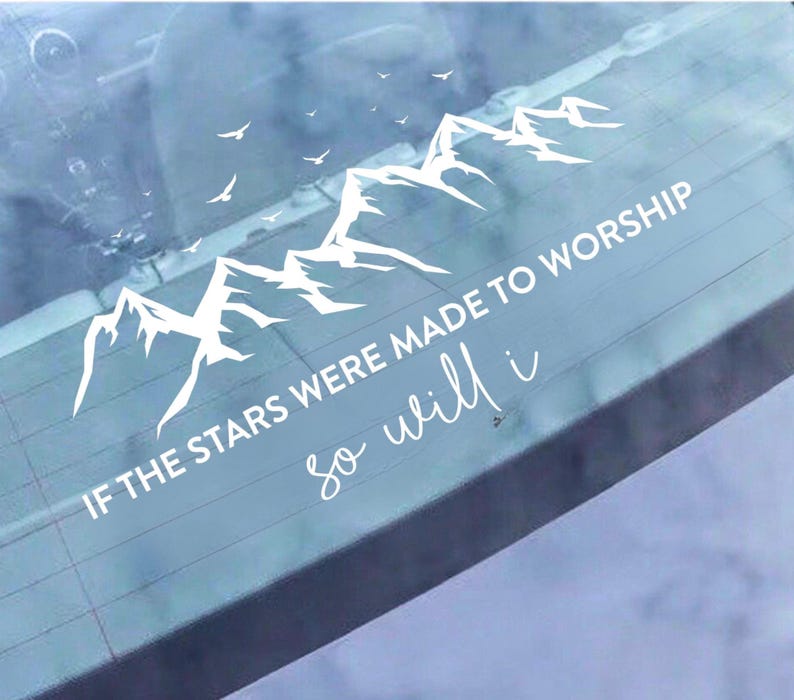 May include: White vinyl decal with a mountain range and birds. The text says "IF THE STARS WERE MADE TO WORSHIP so will i" in a script font. Designed for application on a car window, it has a spiritual theme.