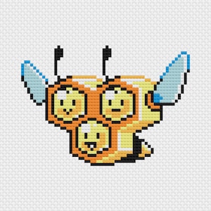 May include: A pixelated image of a cartoon bee with three smiling faces. The bee is primarily orange and yellow, with black antennae and wings outlined in blue. The design is reminiscent of cross-stitch.